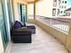Balcony with seating and an open sliding door to condo interior at 1180 Gulf Blvd # 306, Clearwater, FL 33767