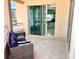 Balcony with seating area and open door to interior at 1180 Gulf Blvd # 306, Clearwater, FL 33767