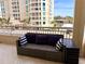 Relax on this balcony with a comfortable couch with outdoor furniture at 1180 Gulf Blvd # 306, Clearwater, FL 33767