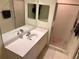 Bright bathroom with a vanity sink, large mirror, and glass-enclosed shower at 1180 Gulf Blvd # 306, Clearwater, FL 33767
