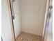 Bright tiled shower with glass door and shower head at 1180 Gulf Blvd # 306, Clearwater, FL 33767
