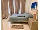 Relaxing bedroom featuring large windows, neutral tones, and comfortable furniture at 1180 Gulf Blvd # 306, Clearwater, FL 33767