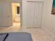 Bright bedroom featuring a neutral palette, double closets, and adjacent bathroom at 1180 Gulf Blvd # 306, Clearwater, FL 33767