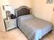 Cozy bedroom featuring a comfortable bed and stylish nightstand with elegant lamp at 1180 Gulf Blvd # 306, Clearwater, FL 33767