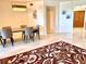 Bright dining room showcasing marble floors, modern chandelier, seating for four and beach themed area rug at 1180 Gulf Blvd # 306, Clearwater, FL 33767