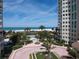 Beautiful landscaping featuring palm trees and manicured grounds, with stunning views of the white sandy beach and ocean at 1180 Gulf Blvd # 306, Clearwater, FL 33767