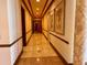 Inviting hallway with elegant marble flooring, framed artwork, and detailed trim work at 1180 Gulf Blvd # 306, Clearwater, FL 33767