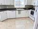Bright kitchen featuring white cabinets, modern appliances, and plenty of counter space at 1180 Gulf Blvd # 306, Clearwater, FL 33767