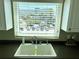 Kitchen sink with a window overlooking the parking lot with palm trees at 1180 Gulf Blvd # 306, Clearwater, FL 33767