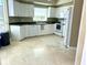 Bright kitchen with white cabinetry, countertops, and flooring at 1180 Gulf Blvd # 306, Clearwater, FL 33767