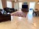 Spacious living room featuring marble flooring, comfortable seating, and modern entertainment center at 1180 Gulf Blvd # 306, Clearwater, FL 33767