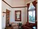 Bright living room featuring a comfortable sofa, bookcase, and a large window with views of lush greenery and the beach at 1180 Gulf Blvd # 306, Clearwater, FL 33767