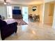 Open living area with tile floors, dining table, and sliding glass doors to the outside balcony at 1180 Gulf Blvd # 306, Clearwater, FL 33767