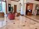 Inviting lobby with comfortable seating, tiled floors, decorative columns, and artwork creating a welcoming atmosphere at 1180 Gulf Blvd # 306, Clearwater, FL 33767