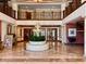 Elegant lobby with fountain, marble floors, columns, a mezzanine, and comfortable seating, showcasing a luxurious atmosphere at 1180 Gulf Blvd # 306, Clearwater, FL 33767