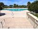 Large swimming pool surrounded by lounge chairs and lush tropical landscaping at 1180 Gulf Blvd # 306, Clearwater, FL 33767