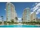 Stunning view of high-rise buildings from the pool with palm trees, perfect for relaxation and luxury living at 1180 Gulf Blvd # 306, Clearwater, FL 33767