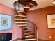 Unique spiral staircase with wooden steps and decorative metal railing creates an architectural statement at 1180 Gulf Blvd # 306, Clearwater, FL 33767