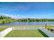Spacious backyard with a white picket fence and a view of the water, perfect for relaxing outdoors at 1210 Harbour Blue St, Ruskin, FL 33570