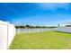 Fenced backyard with lush green grass and view of waterway, ideal for outdoor activities at 1210 Harbour Blue St, Ruskin, FL 33570