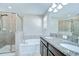 Bathroom featuring a tiled shower, soaking tub, and double vanity with granite countertops at 1210 Harbour Blue St, Ruskin, FL 33570