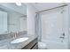 Well-lit bathroom featuring granite countertop, ample mirror space, and a shower-tub combo at 1210 Harbour Blue St, Ruskin, FL 33570
