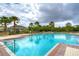 Inviting community pool with ample seating, palm trees, and a covered pavilion at 1210 Harbour Blue St, Ruskin, FL 33570