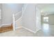 Inviting entryway featuring wood-look tile flooring and a staircase leading to the upper level at 1210 Harbour Blue St, Ruskin, FL 33570