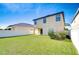 Back of home with large, fenced yard featuring well-maintained lawn, providing a safe play area at 1210 Harbour Blue St, Ruskin, FL 33570
