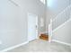 Bright foyer with tile flooring, staircase, and neutral paint, offering a grand entrance to the home at 1210 Harbour Blue St, Ruskin, FL 33570