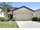 Charming two-story home featuring a manicured lawn, two-car garage, and welcoming curb appeal at 1210 Harbour Blue St, Ruskin, FL 33570