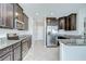 Well-equipped kitchen featuring dark wood cabinets, stainless steel appliances, and granite countertops at 1210 Harbour Blue St, Ruskin, FL 33570