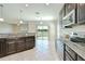 Bright kitchen featuring stainless steel appliances, granite countertops, and an adjacent dining area at 1210 Harbour Blue St, Ruskin, FL 33570