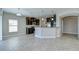 Modern kitchen with dark wood cabinets, granite countertops, and stainless steel appliances with tile flooring at 1210 Harbour Blue St, Ruskin, FL 33570