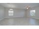 Spacious living room with tile flooring, a ceiling fan, and ample natural light from large windows at 1210 Harbour Blue St, Ruskin, FL 33570