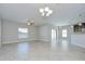 Open living space with tile floors, a ceiling fan, and sliding glass doors leading to the outside at 1210 Harbour Blue St, Ruskin, FL 33570