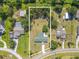 Wide aerial shot showcases the property's location amidst lush greenery and neighborhood amenities at 12220 Twin Branch Acres Rd, Tampa, FL 33626
