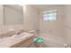 Well-lit bathroom with a tub and shower, a vanity, and tiled walls at 12220 Twin Branch Acres Rd, Tampa, FL 33626