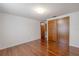 Bedroom with hardwood floors, closet, and a neutral color palette throughout at 12220 Twin Branch Acres Rd, Tampa, FL 33626