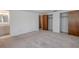 Large carpeted bedroom featuring an attached bathroom and closet at 12220 Twin Branch Acres Rd, Tampa, FL 33626