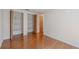 Bedroom with hardwood floors, large closet with shelving, and natural light at 12220 Twin Branch Acres Rd, Tampa, FL 33626