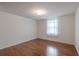 Well-lit bedroom featuring hardwood floors and a window that allows natural light at 12220 Twin Branch Acres Rd, Tampa, FL 33626
