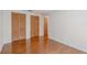 Bedroom with hardwood floors, closet with louvered doors and natural light at 12220 Twin Branch Acres Rd, Tampa, FL 33626