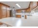 Bright kitchen with stainless steel appliances, ample counter space, and plenty of storage in wooden cabinets at 12220 Twin Branch Acres Rd, Tampa, FL 33626