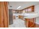 A well-lit kitchen includes wood cabinets, stainless steel appliances, and a breakfast bar at 12220 Twin Branch Acres Rd, Tampa, FL 33626