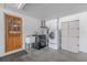 Laundry room with modern washer/dryer, wash sink, and plenty of storage at 12220 Twin Branch Acres Rd, Tampa, FL 33626