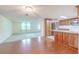 Open-concept living space with beautiful flooring flows into a kitchen with wood cabinets at 12220 Twin Branch Acres Rd, Tampa, FL 33626