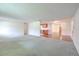 Open-concept living room leading into the kitchen, featuring a mix of carpet and hardwood flooring at 12220 Twin Branch Acres Rd, Tampa, FL 33626