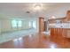 Open-concept living space flows into a kitchen with wood cabinets and stainless steel appliances at 12220 Twin Branch Acres Rd, Tampa, FL 33626