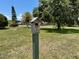 Charming birdhouse nestled in a lush green yard, adding character to the landscape at 12220 Twin Branch Acres Rd, Tampa, FL 33626